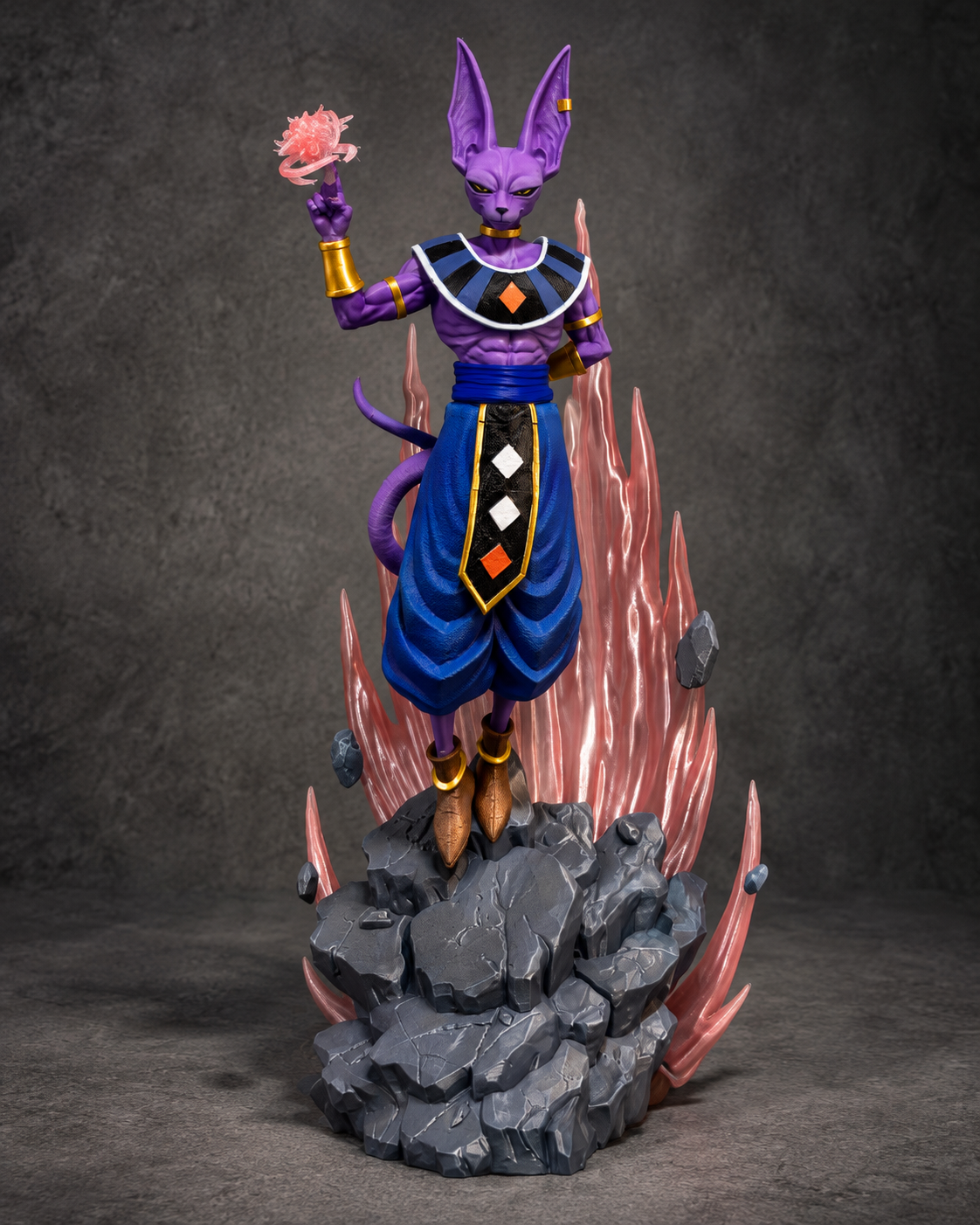 Purple deity statue with pink energy aura on grey rocky display base