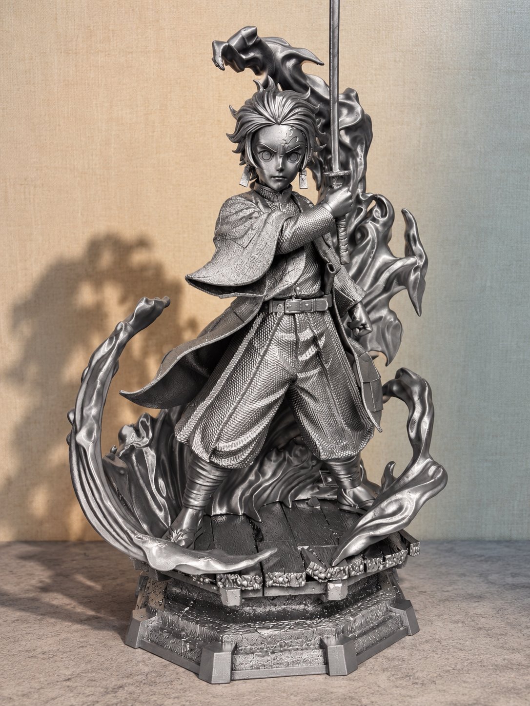 Silver finish 40 cm swordsman statue with swirling sculpted effects